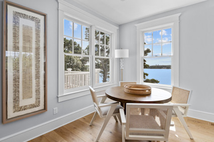 A bright sunroom with panoramic water views at Fox Hill, a Pacaso home in Chatham on Cape Cod.