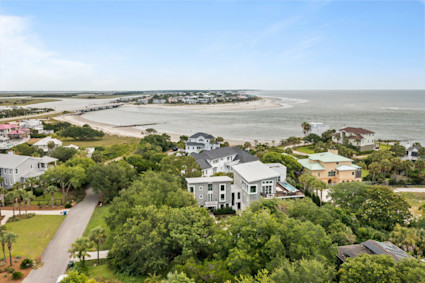 aerial view showcasing a luxury coastal home with a water view, ideal for early fall golf getaways on Kiawah Island, SC