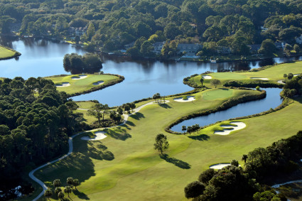 Aerial view of a golf course with ponds and trees