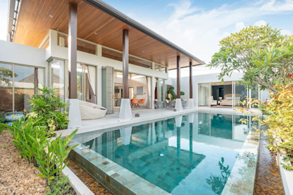 Wood modern house and pool surrounded by trees