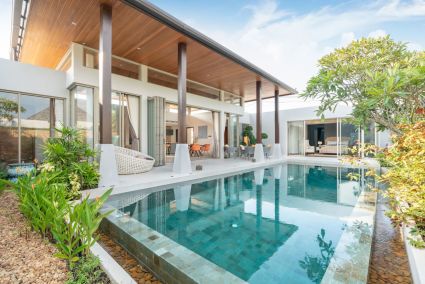 Wood modern house and pool surrounded by trees