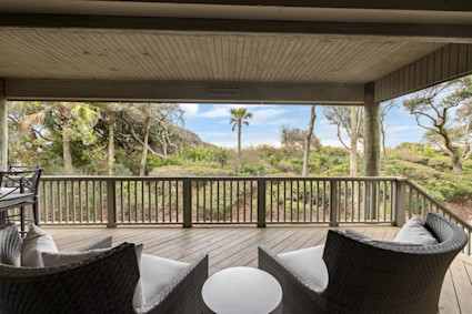 Palmetto Cove’s deck offers a peaceful escape or the ideal setting for an intimate, post-event cocktail hour, showcasing how Pacaso owners can blend exclusive island experiences with oceanfront comfort.