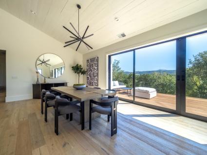 Living room with large windows and an eight person table