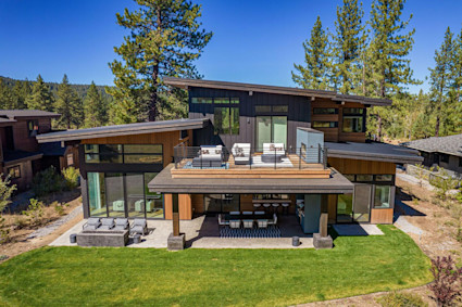 The outdoor lounge and patio at Pine Point in Truckee are expertly designed for both relaxed gatherings and formal dining, nestled amidst woodland views. This Pacaso home’s covered patio, built-in grill, and fire pit invite al fresco meals that linger into the evening.