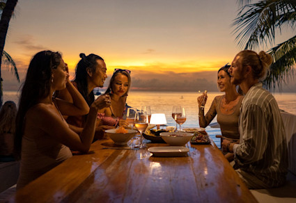 A group of friends sit at a table at Rooftop 360, an incredible thing to do in Cabo.