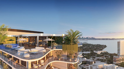 Luxury penthouse rooftop terrace with infinity pool, lush greenery, and sweeping Miami waterfront views at sunset.
