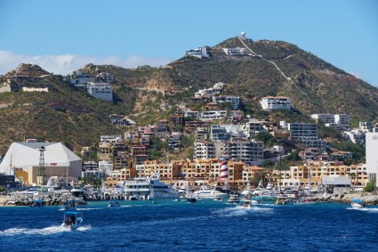 The view of the port, the luxury resorts hotels and waterfront homes on top of the hill on a sunny day