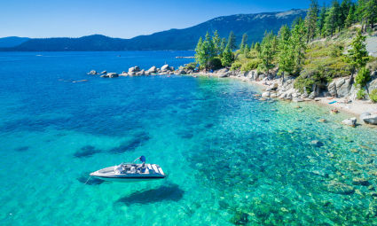 A lone boat cruises around Lake Tahoe in summer.