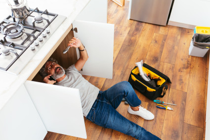 person working on sink maintenance