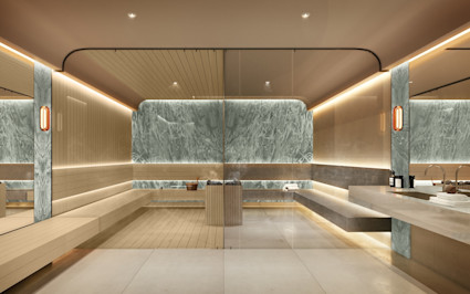 Upscale spa sauna with wood-slatted benches, green marble accent wall, warm LED lighting, glass partition, and luxury bath amenities.