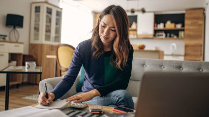 A person sits at home and reviews her second home tax deductions. 