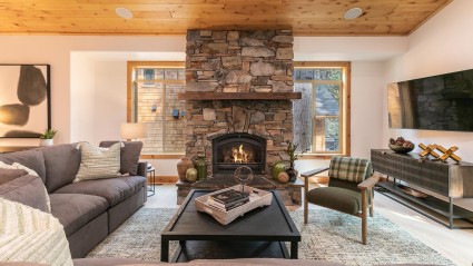 living room with stone fireplace and comfy couches