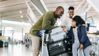 Why do people travel? A family at an airport with their luggage in tow has answered the question for themselves.