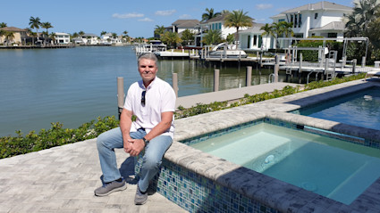 Photo of agent, Eugene in a Pacaso home while sitting on a hot tub.