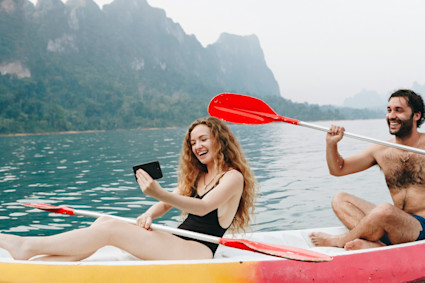 A couple kayaking on calm water symbolizes the peaceful outdoor adventures available in Marco Island and similar coastal towns during the crowd-free late summer months.