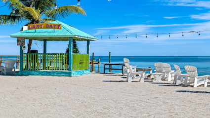 A colorful beach hut with casual seating in the Florida Keys, representing the relaxed, inviting atmosphere of the destination.