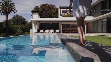 thumbnail for brand video - woman walking by pool
