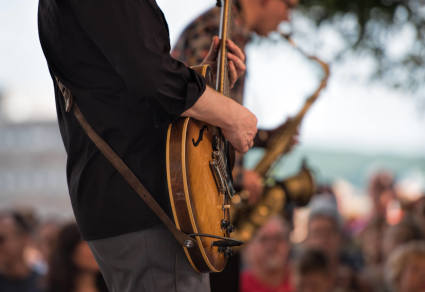 A person plays the guitar near Lake Tahoe.