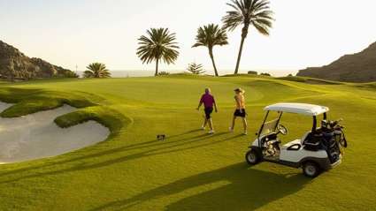 A couple finishes a round of golf at a scenic snowbird destination.