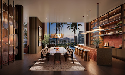 Elegant amenity lounge with long dining table, bar seating, open shelving, and floor-to-ceiling city and palm tree views at dusk.