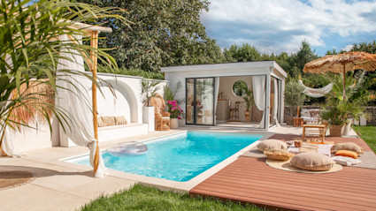 A luxury vacation home with a pool and deck.