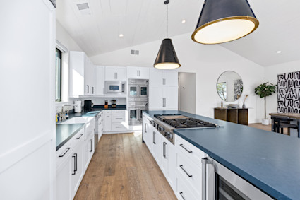 Olive Grove in Healdsburg, Sonoma County, showcases a bright, open kitchen with white cabinetry, ideal for preparing fresh, seasonal meals or entertaining guests in true wine country style.