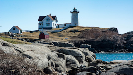 Cape Cod's classic lighthouses and rocky coastline evoke timeless elegance, setting the scene for luxury waterfront living.