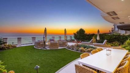 Ocean-facing patio with sunset views, seating and a fire pit