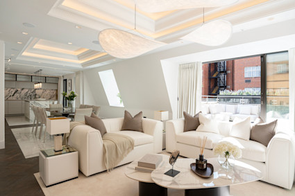 A calm palette with sculptural lighting and refined millwork demonstrates color used with intent in a city setting.