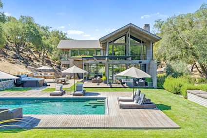 Napa Valley home featuring a swimming pool, hot tub, and lawn, exemplifying private, easy-to-maintain luxury for those embracing a lock-and-leave lifestyle.