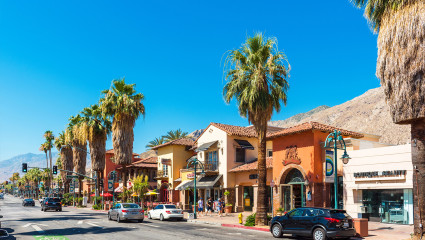 Palm trees and upscale businesses fill the desert oasis of Palm Springs, California, embodying why it’s one of the best places for a second home.