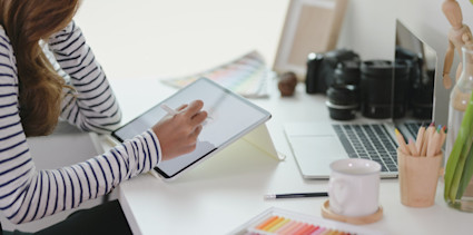 women using tablet at her desk