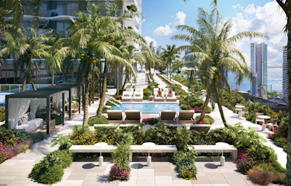 Resort-style rooftop pool deck with palm trees, lounge chairs, draped cabanas, tropical landscaping, and waterfront city skyline views.