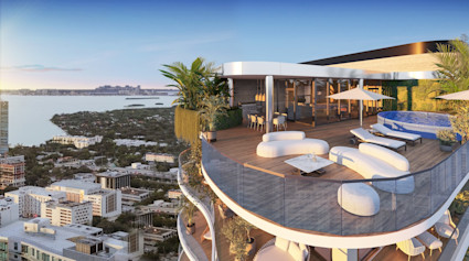 Expansive penthouse rooftop deck with plunge pool, loungers, and unobstructed Miami bay and city views at dusk.