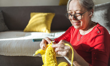 A person practices knitting, one of the many hobbies for empty nesters.