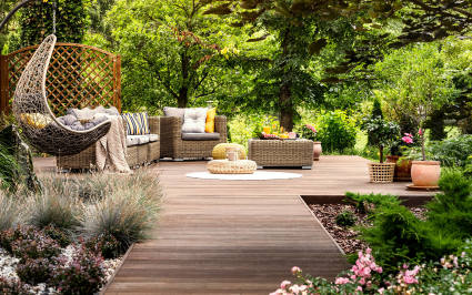 An image of a luxurious courtyard setting amidst a lush forest background.