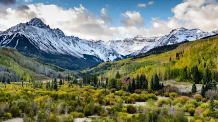 An image showcases snow-capped mountains, the symbols of luxury mountain getaways.