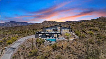 Desert Haven's hilltop perch and infinity pool offer privacy and views, creating a striking setting for sunset hosting near Scottsdale.