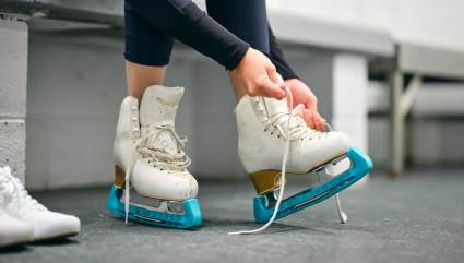 A person putting on their skates at Howelsen Ice Arena, one of the top places for Steamboat Springs summer activities.