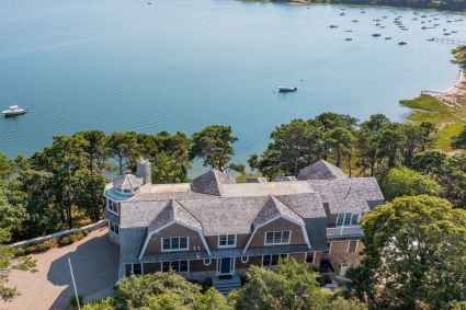 An aerial view of a spacious vacation home on Cape Cod, offering a picturesque waterfront setting