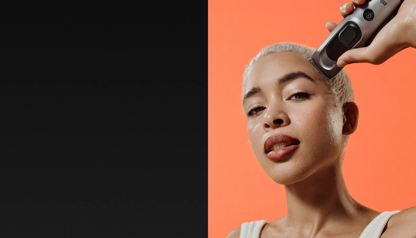 Woman using hairclipper on head