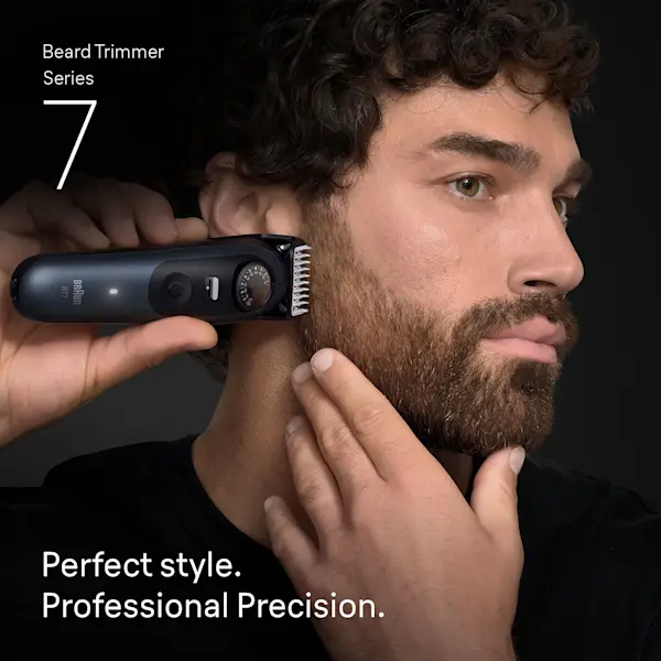 Young man trimming his beard on the side of his face with the Braun Beard Trimmer Series 7