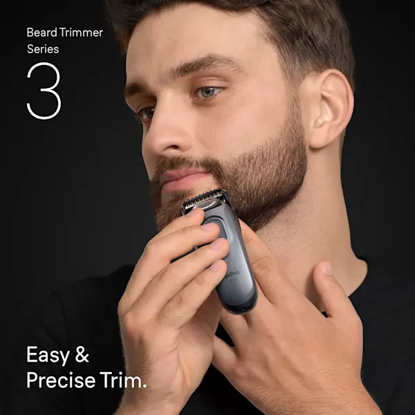 Young man trimming the beard on his chin with the Braun Beard Trimmer Series 3