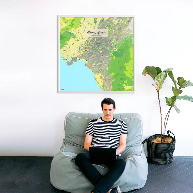 Athen-Stadtkarte als Poster im Jalma Design in einem Wohnzimmer mit Mann und Laptop