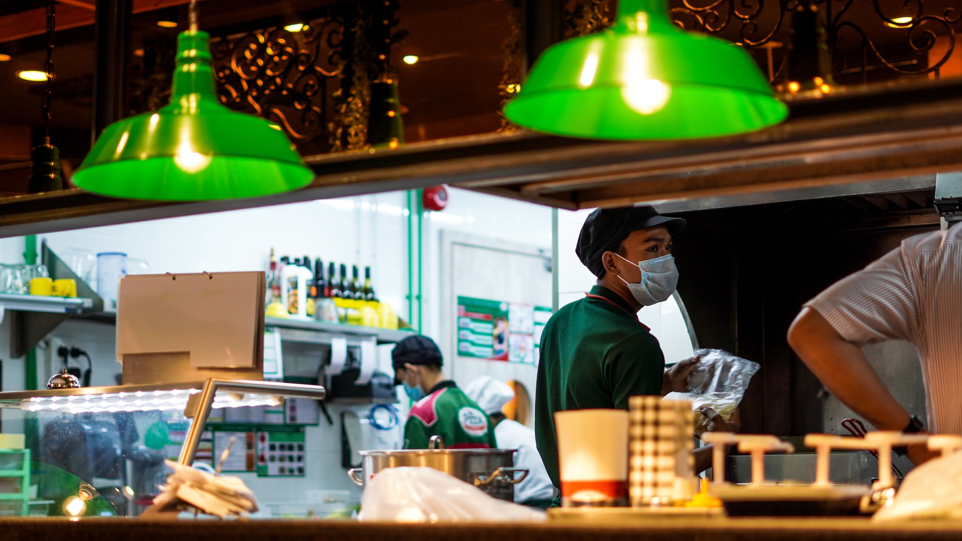 asian-restaurant-staff-green-uniforms-in-kitchen