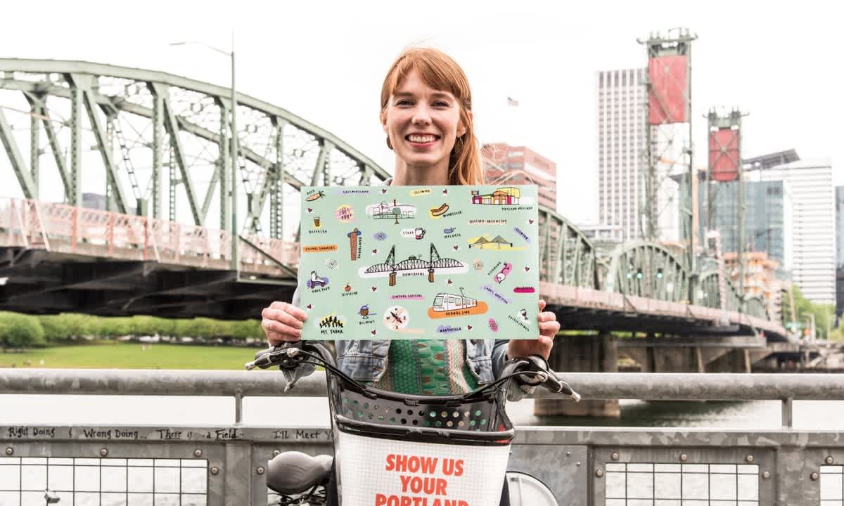 Winning artist Marguerite Schumm poses with her bike wrap design