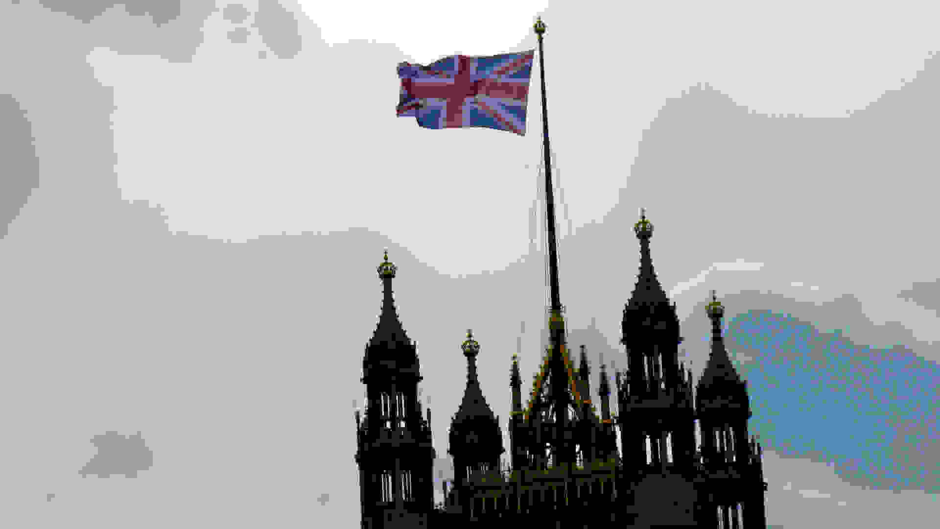 The Union Jack flying atop the Victoria Tower of the UK Houses of Parliament