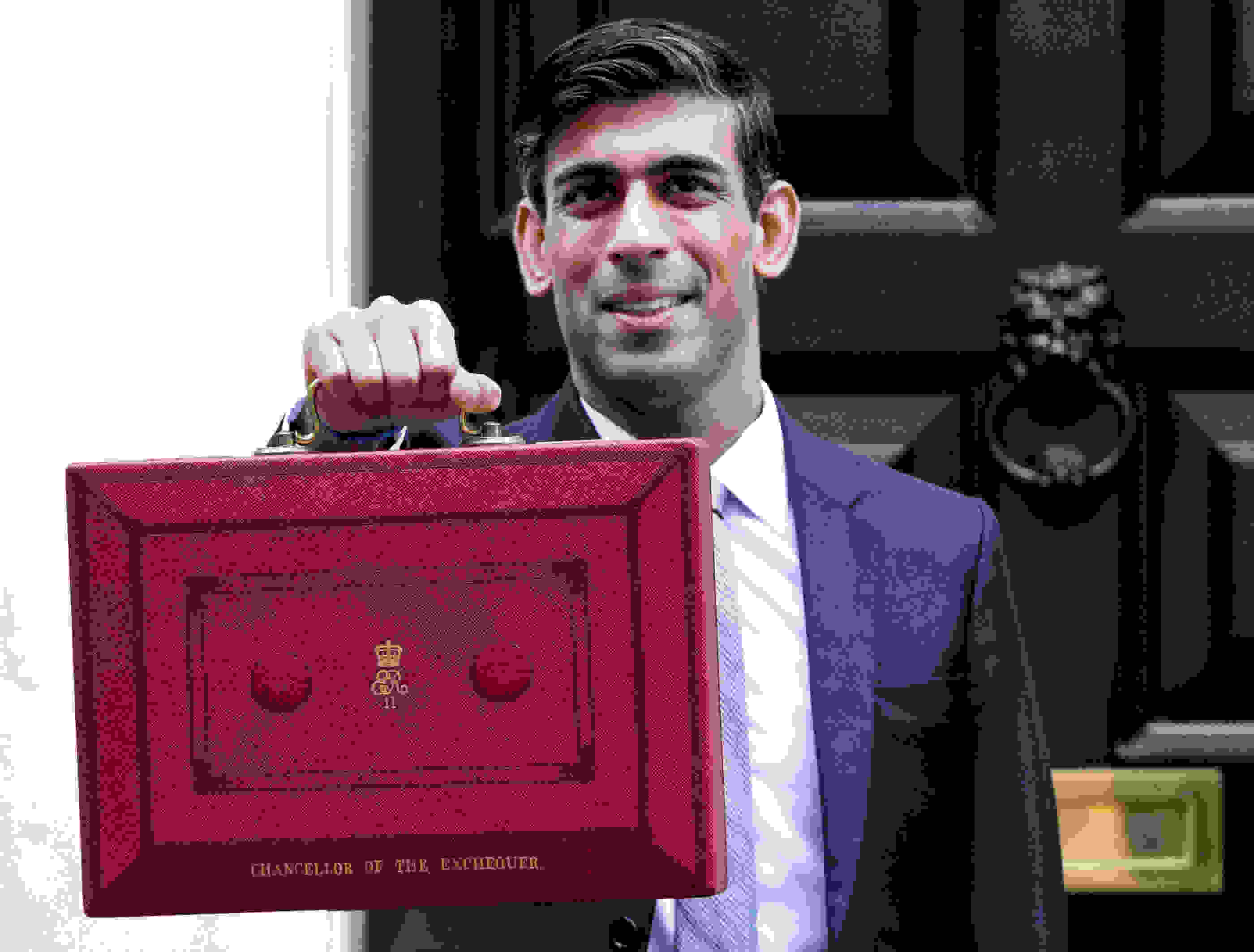 Chancellor of the Exchequer Rishi Sunak holds up the red box outside Number 11 on his first Budget. Picture by Harriet Pavey/ No 10 Downing Street