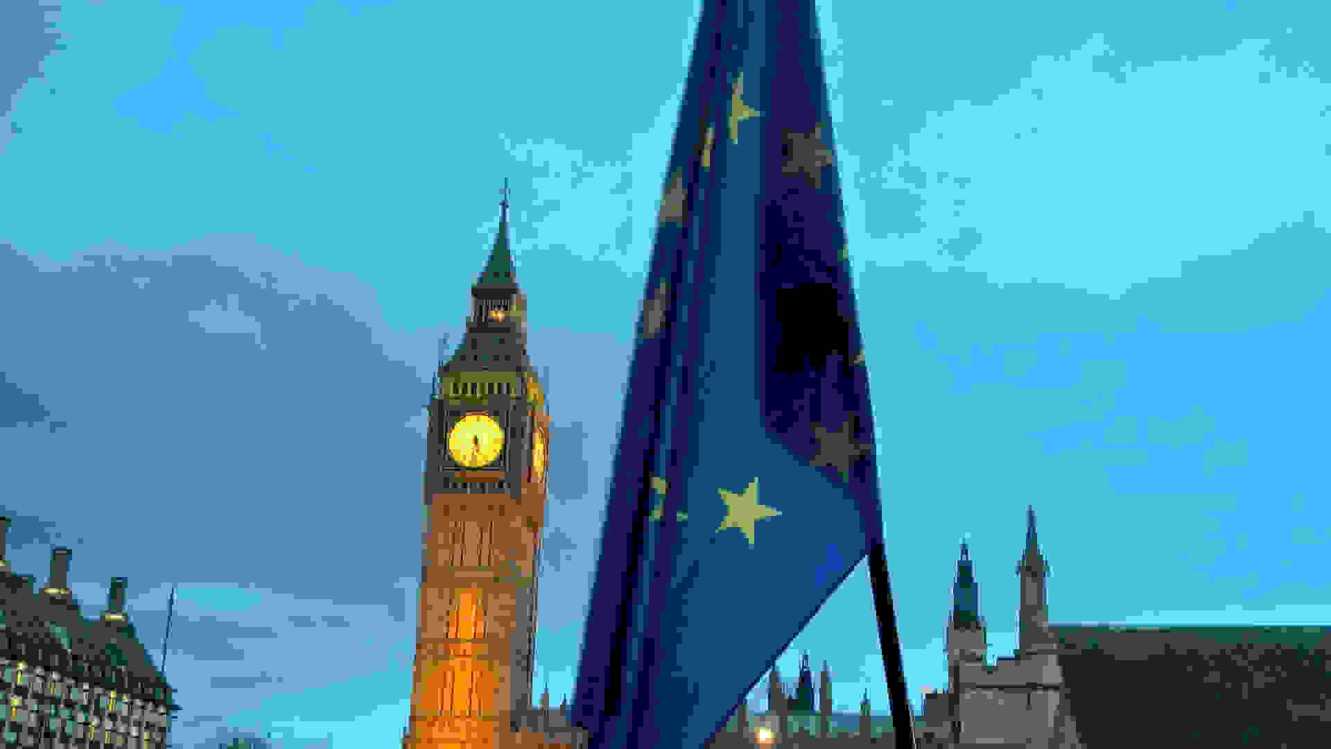 The EU flag in the foreground and Big Ben in the background during a protest in Parliament Square, Westinster