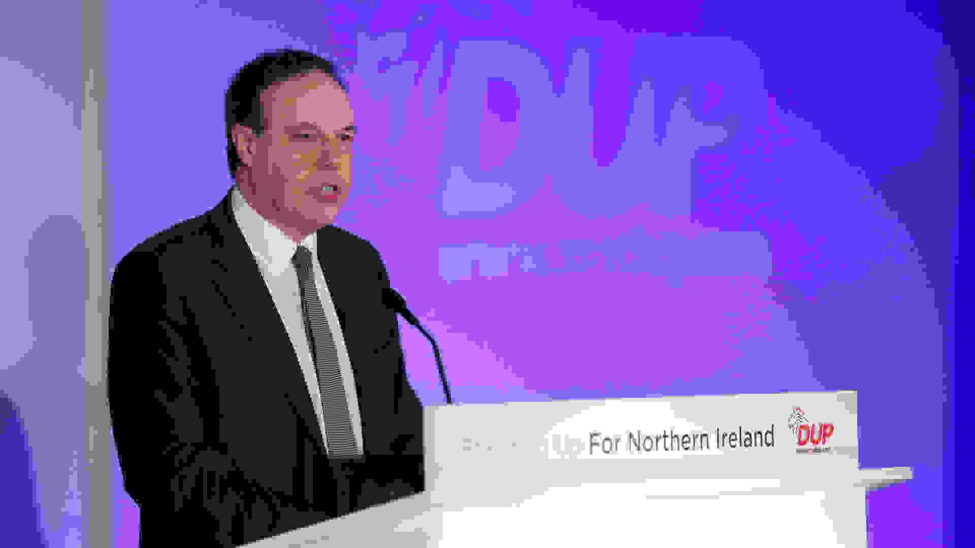 Deputy Leader of the Democratic Unionist Party Nigel Dodds giving a speech during a DUP conference. Democratic Unionist Party, Licensed under the Creative Commons Attribution 2.0 Generic